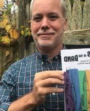 Matt Bell holding a copy of the book The Boys in the Band